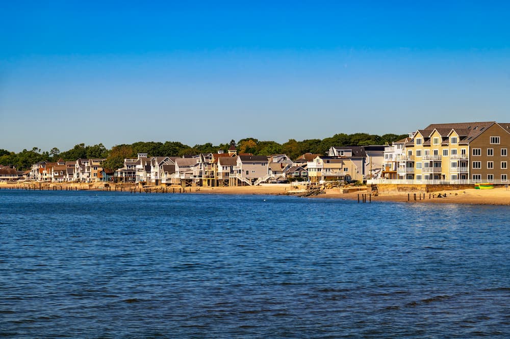 Coastal view of residential homes and beachfront buildings along Walnut Beach in Milford, Connecticut, USA